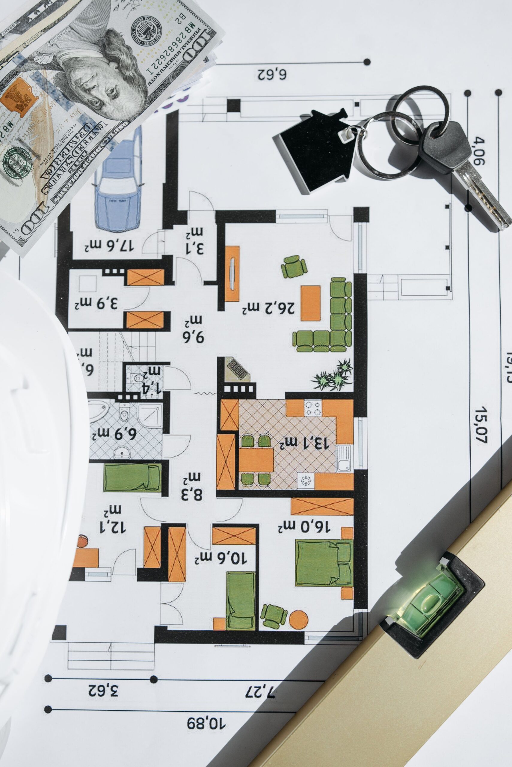 Property purchase financing with cash, keys and a house plan