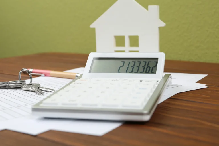 Buying Property With Cash or a Mortgage? House keys and calculator used for mortgage planning