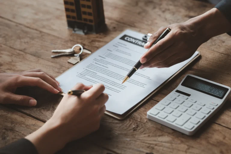 The Hidden Costs of Buying Property in Europe Property purchase contract with keys and calculator