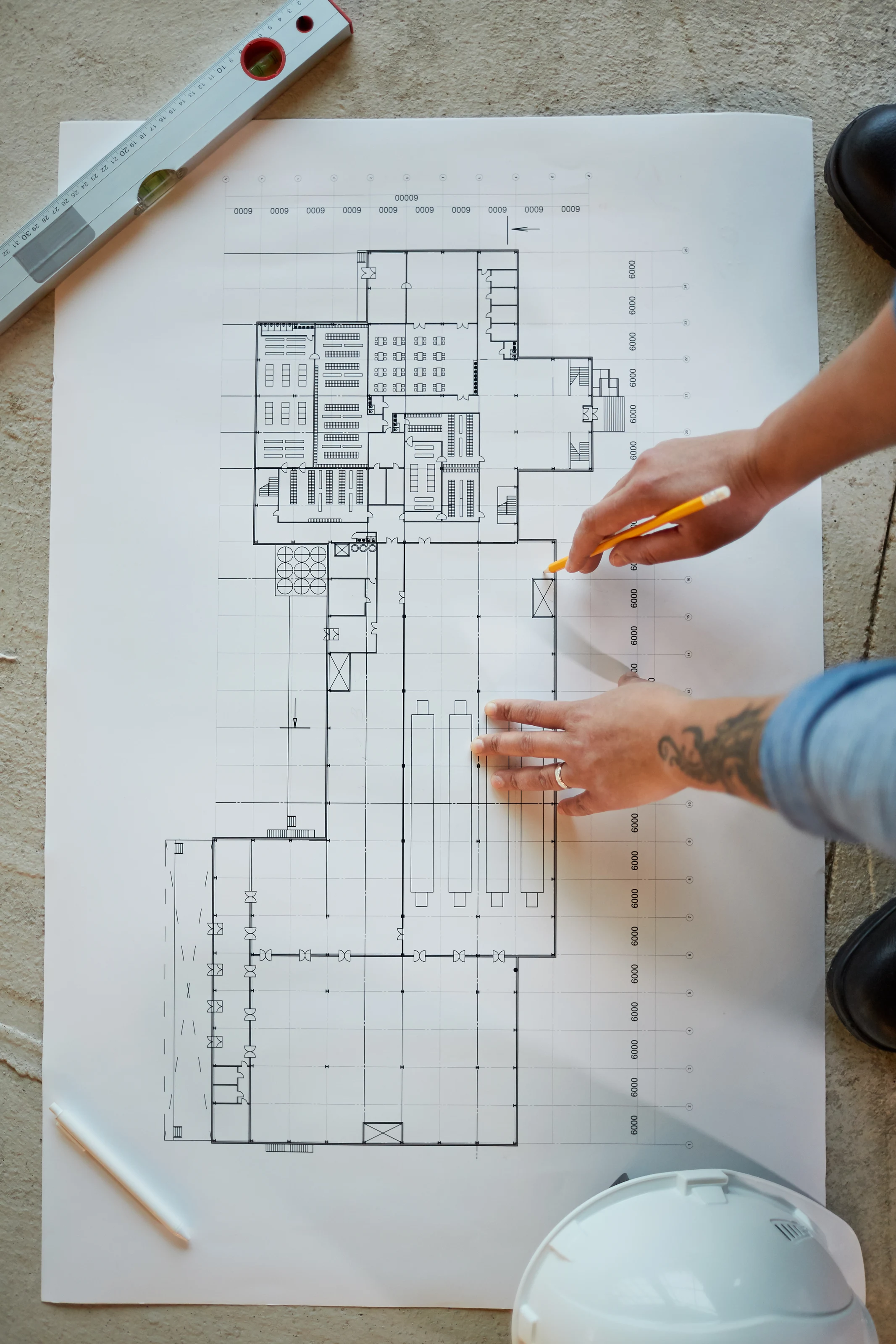 Investor reviewing residential plans and property market information